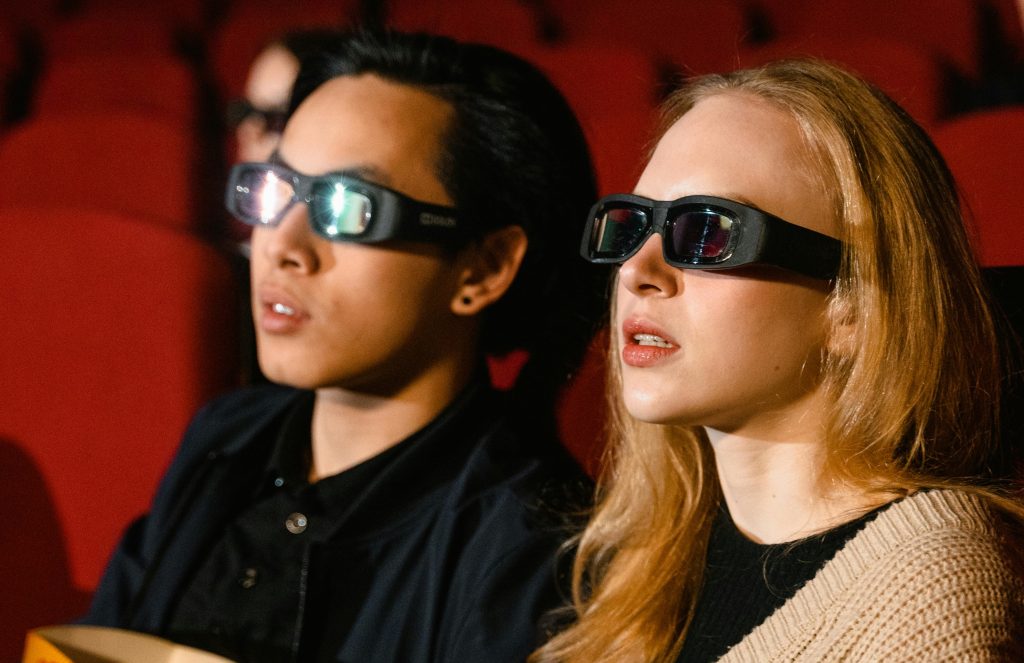 a couple wearing 3D TV glasses